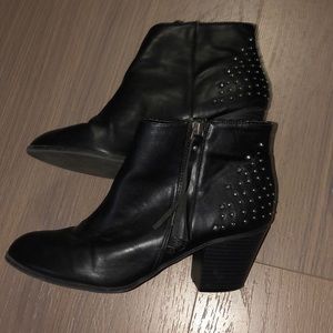 Studded black booties with tassel zippers